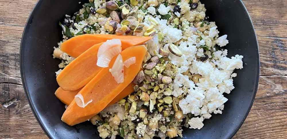 A grain bowl featuring Moroccan carrot couscous.