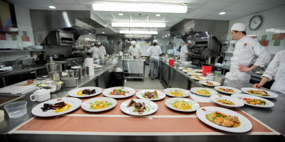 Students prepping for mock service in the ICE kitchen