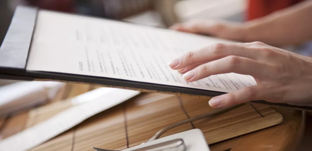 A diner holds a restaurant menu