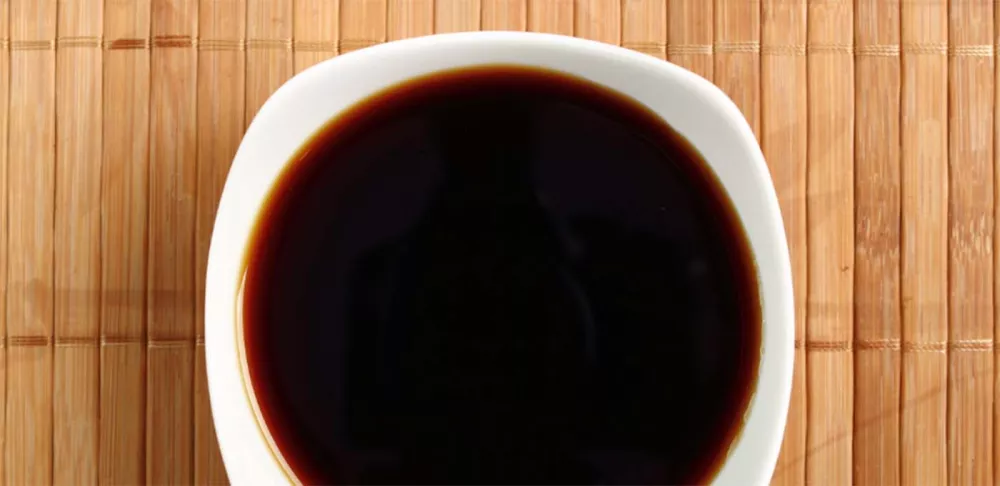 A bowl of soy sauce.