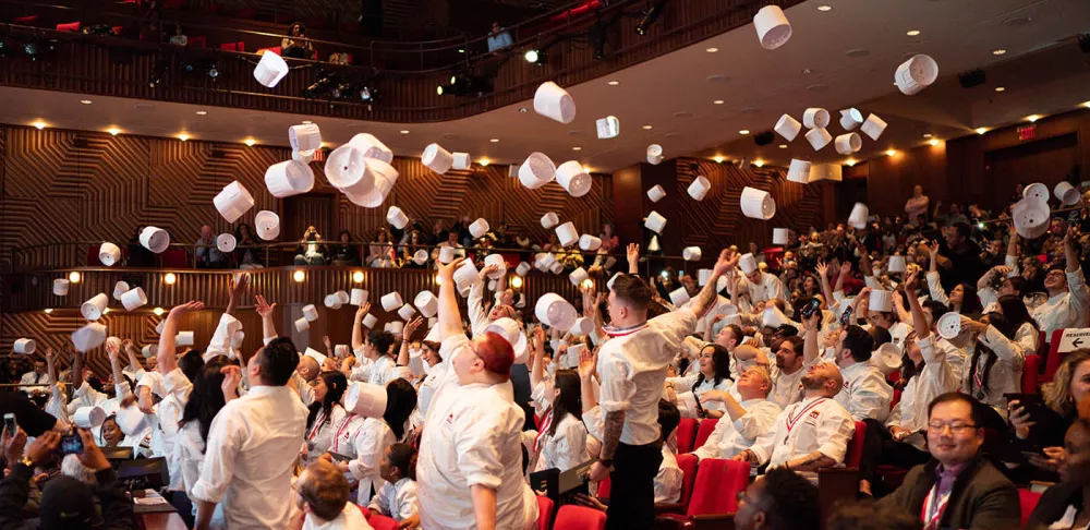 ICE graduates toss their toques at the 2019 commencement.