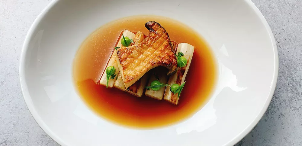 Fermented Mushroom and toasted barley broth, coal-grilled king oyster mushroom, salsify and tarragon emulsion