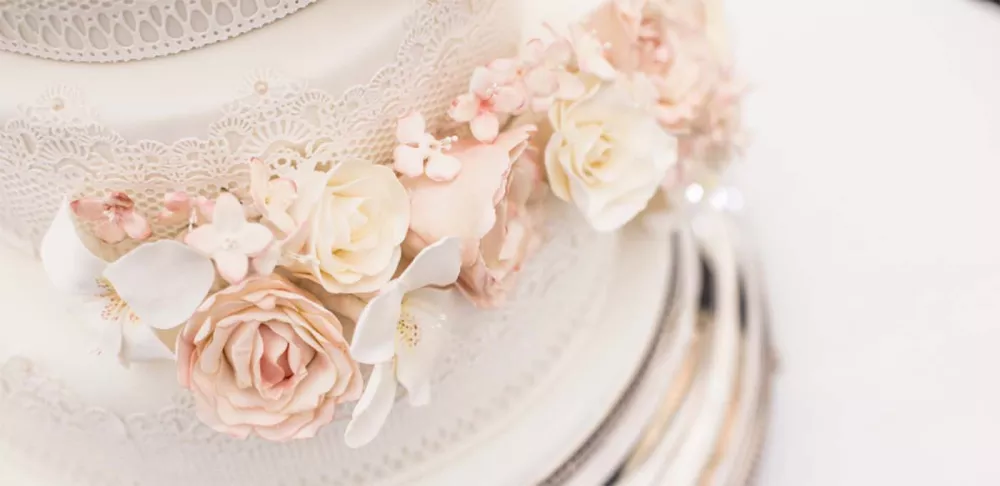 A decorated wedding cake with sugar flowers