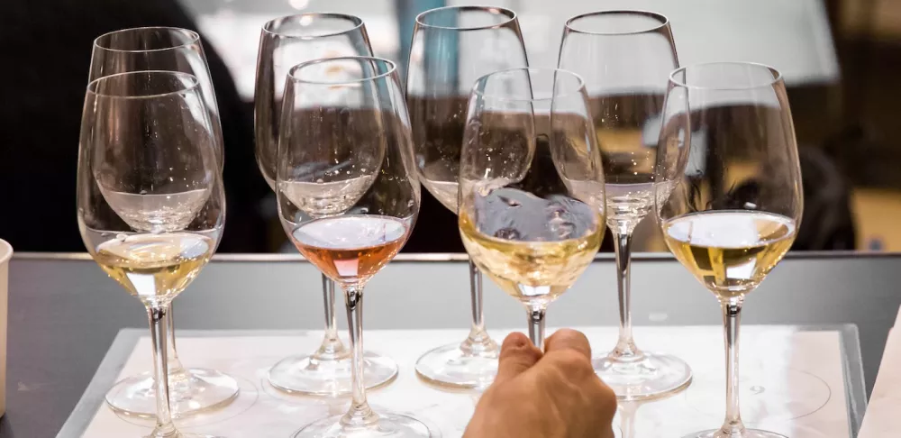 A student tastes white wines