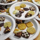 Plates with nine varieties of cookies piled on top of each other