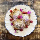 Three fermented Sweet rhubarb, raspberry Jam & ricotta pastries sit on a white plate