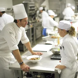 chef speaking to a cook in the restaurant