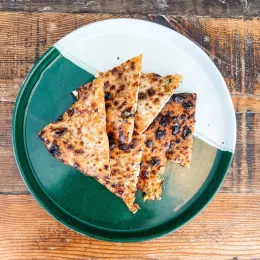 A plate of cheese-stuffed naan.