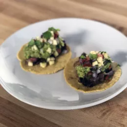 Rib-eye and pineapple pico de gallo tacos on a white plate