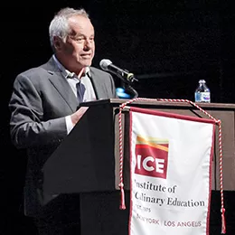 Wolfgang Puck speaks at the Los Angeles campus' first commencement.