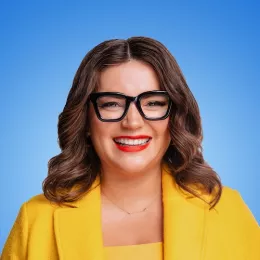 An image with Ellen Bennett, a brunette woman with black framed glasses, smiling