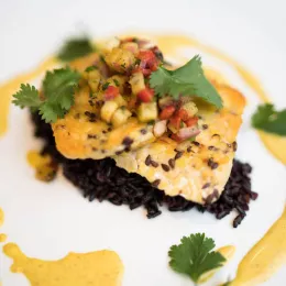 A tempeh and wild rice dish sits on a white plate