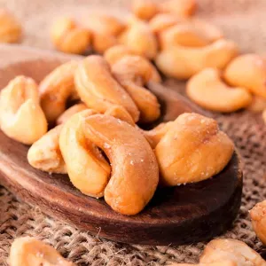 Cashews and a spoon sitting on a table