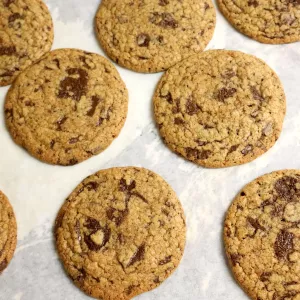 Rows of chocolate chip cookies sit on a tray