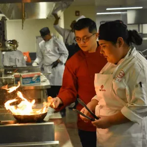 Chef Emerson Majano working on the line in a kitchen.