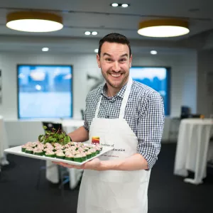 Chris Genovese holding a plant-based hors d'oeuvres at ICE