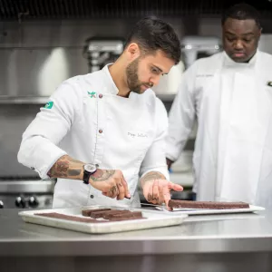 Chef Diego Lozano plates a dessert at ICE's Center for Advanced Pastry Studies in 2017.