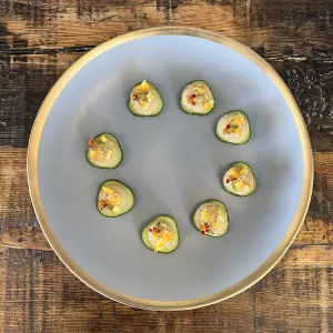 Brined Pine Nut Ricotta Cucumber Rounds with Preserved Orange Rind