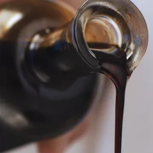 Balsamic vinegar pours from a bottle