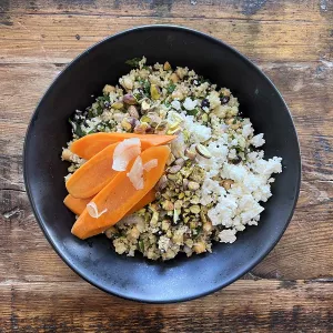 A grain bowl featuring Moroccan carrot couscous.