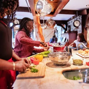 A Black American family preparing food in a kitchen
