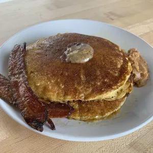 Chef Penny's pancakes are served with candied bacon and apple butter.