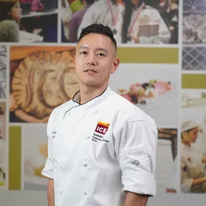 ICE Chef-Instructor Albert Lee faces the camera in his ICE chef jacket