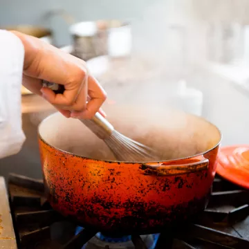 chef cooking using a dutch oven