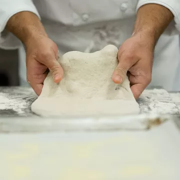 hands kneading dough