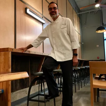 ICE Alum Carlos Jorge in his restaurant, Hi-Craft