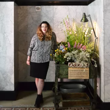 Christina Delli Santi next to flower card at the ACE Hotel in New York