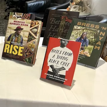 Multiple cookbooks written by Black authors are displayed in ICE's New York campus library