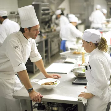 Restaurant chef having intense conversation with cook