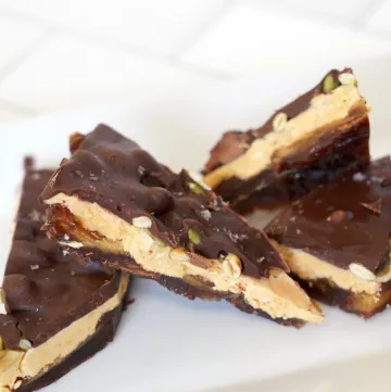 Date bark covered in chocolate on a white plate