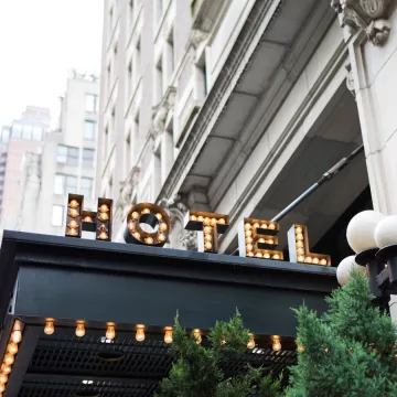 A hotel awning with a light-up sign that reads "HOTEL"