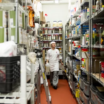 Lauren Jessen walking through stock room in restaurant