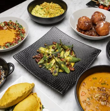 An assortment of dishes from Ubuntu sit on a white tablecloth