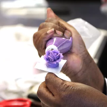 chef piping a frosting rose