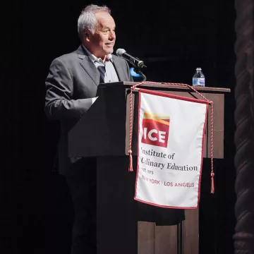 Wolfgang Puck speaks to ICE graduates in Los Angeles.