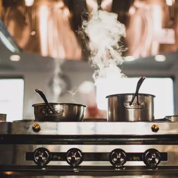 Pots on a stovetop range.