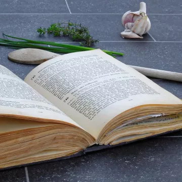 An open cookbook on the kitchen counter.