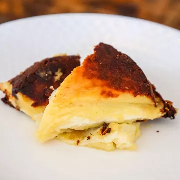 A piece of gatto di patate sits on a white plate