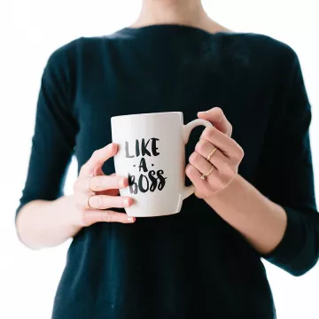 woman holding a like a boss mug