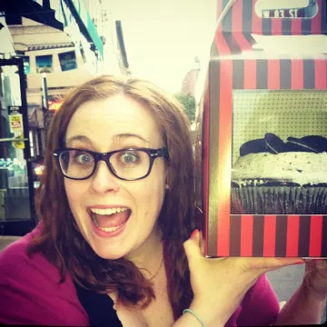 pastry student liz castner holding a cake