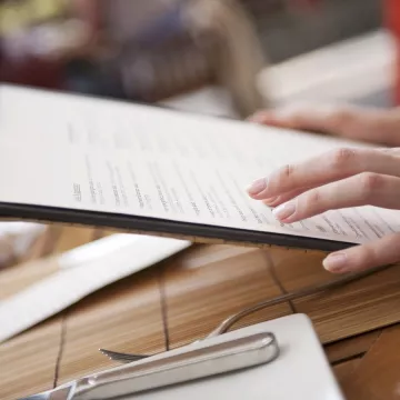 A diner holds a restaurant menu