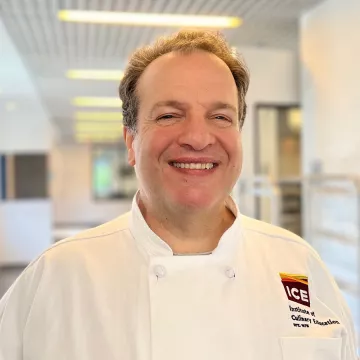 Pastry Chef Richard Kennedy smiles in the ICE hallway