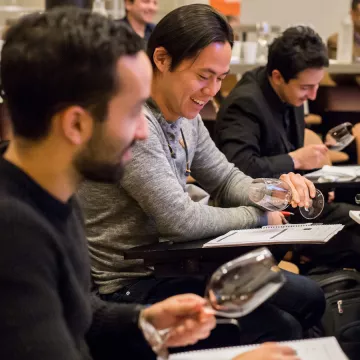 three wine students taste together