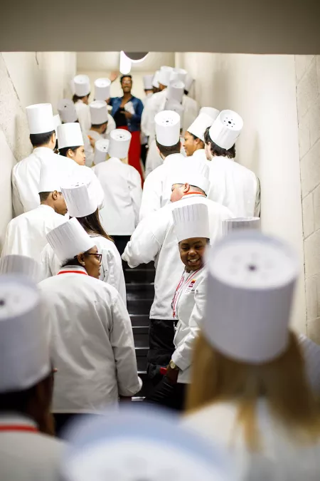 Students get ready to celebrate their graduation ceremony from the Institute of Culinary Education