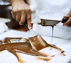 An ICE pastry program student learns to temper chocolate using the traditional method