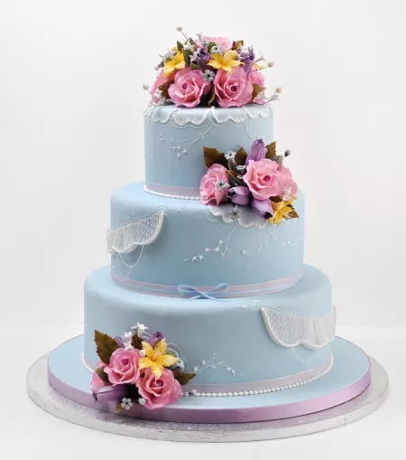 Blue cake with pink gumpaste flowers from the ICE Professional Cake Decorating program